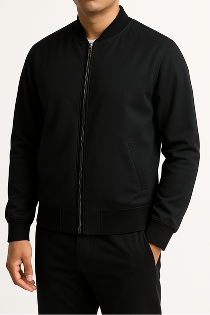 Person wearing a black bomber jacket on a white background