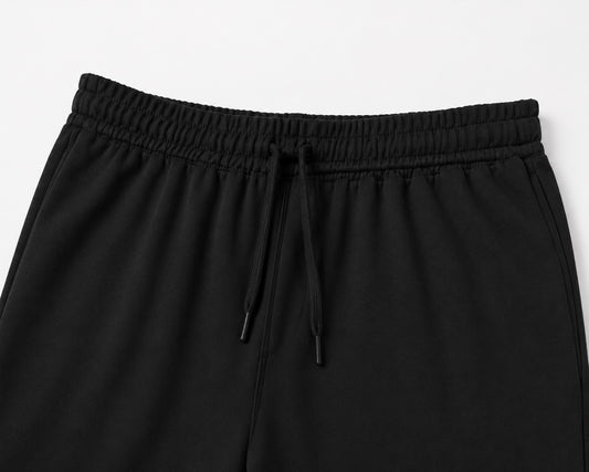 mávros black cotton-blend terry sweatpants featuring a clean elastic waistband with matching drawstring