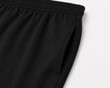 mávros black cotton terry sweatpants with a clean waistband and functional side pocket in a relaxed tapered fit